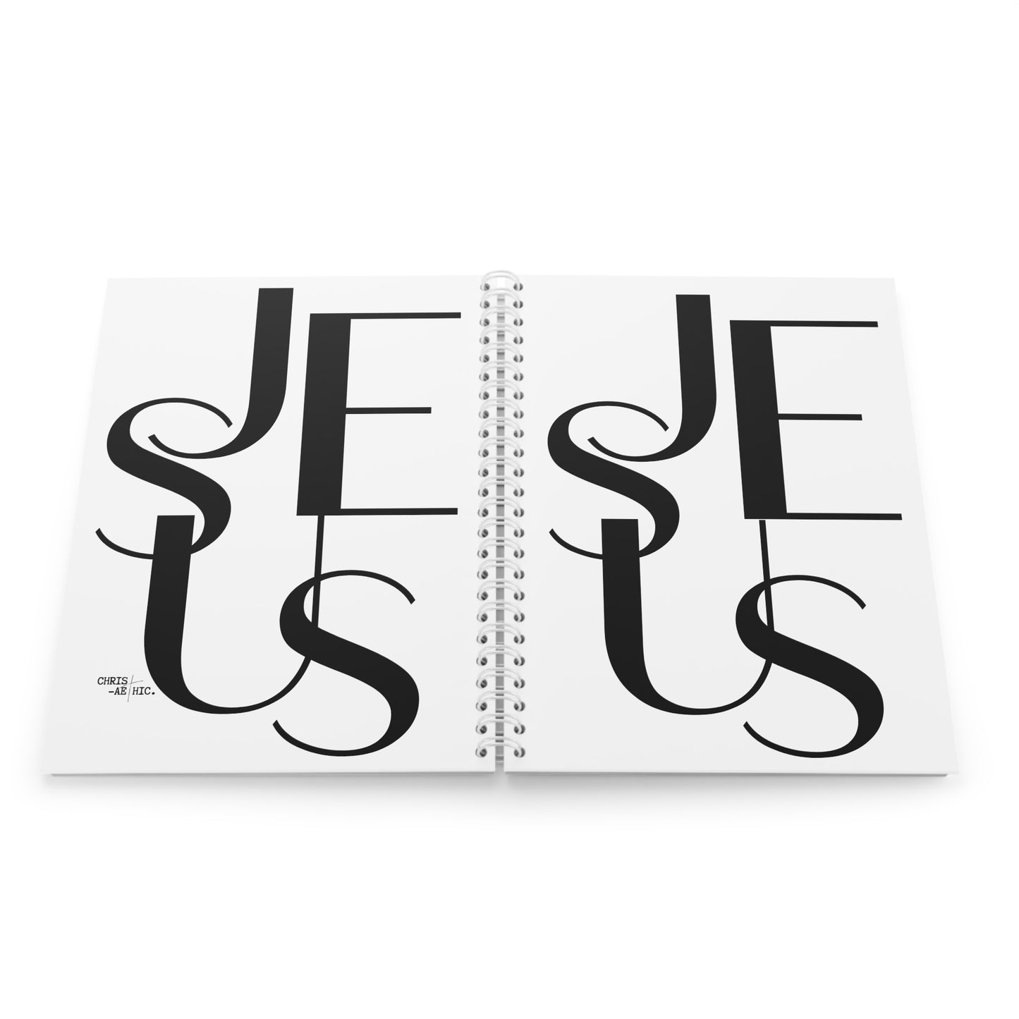 Carnet à spirales blanc avec le mot "JESUS" écrit en noir sur la couverture. Un article de papeterie chrétienne idéal pour la prise de notes et la méditation biblique.