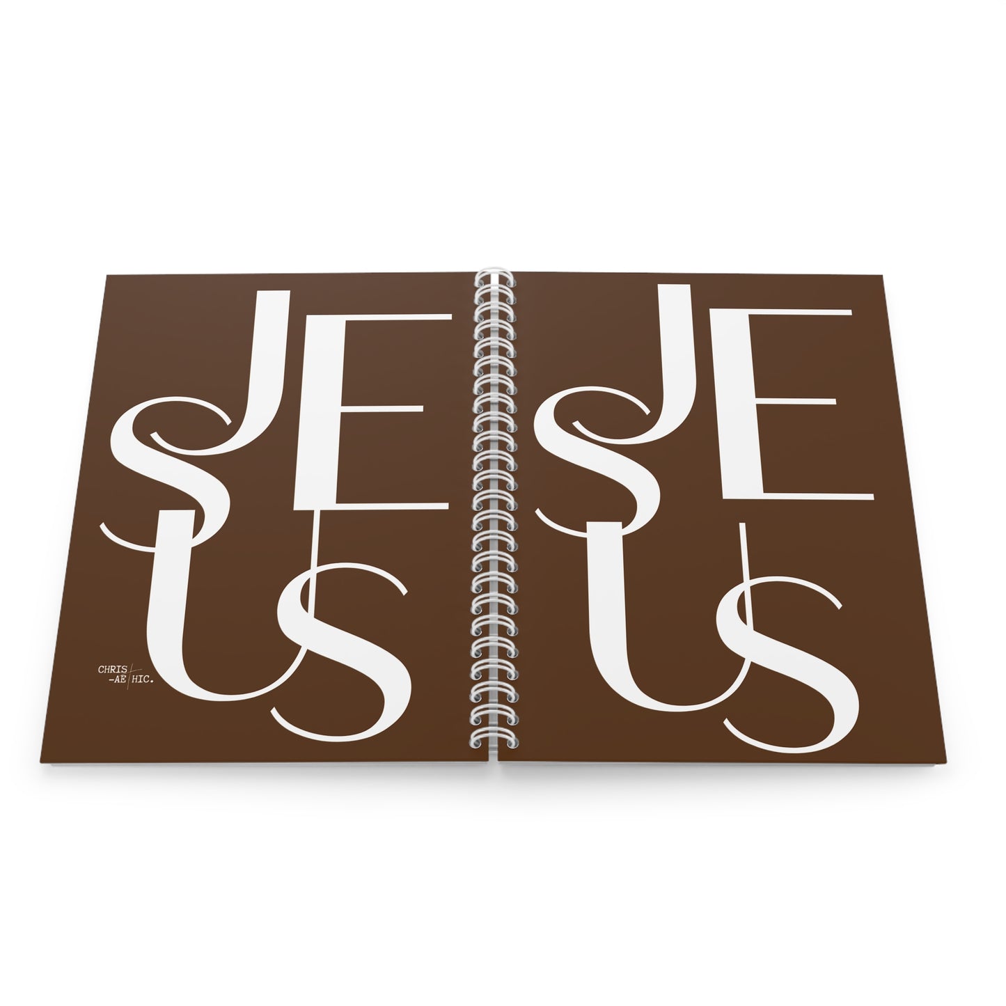 Carnet à spirales blanc avec le mot "JESUS" écrit en blanc sur la couverture marron. Un article de papeterie chrétienne idéal pour la prise de notes et la méditation biblique.